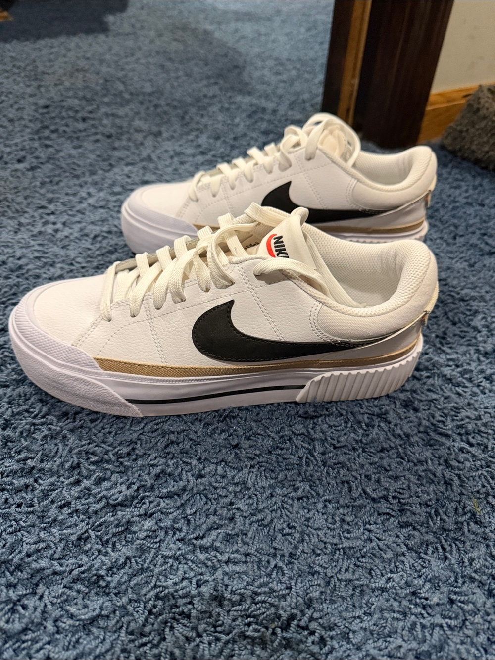 Nike Women’s White Sneakers with Black Swoosh and Gold Trim